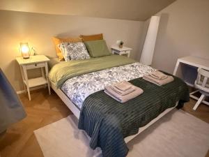 a bedroom with a bed with two towels on it at ScenicOceanview 4Free parking space 18 mins Downtown in Álftanes