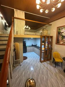 a living room with a staircase and a kitchen at Dốc Phố Home - Dalat Homestay in Xuan An +46 photos