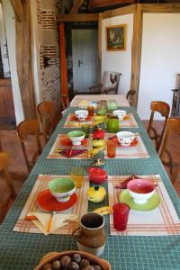 a table with many plates and bowls on it at Chbres D'hôtes Ferme De Champliveau in Bonnée