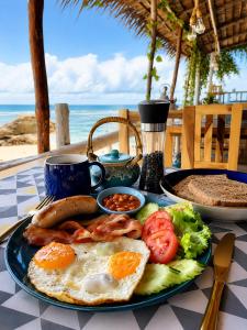 a plate of breakfast food on a table near the beach at Nami by Secret Place in Mae Haad +54 photos