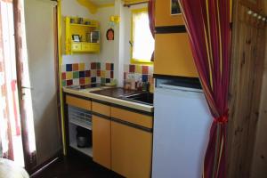 a small kitchen with a sink and a stove at Chbres D'hôtes Ferme De Champliveau in Bonnée +25 photos