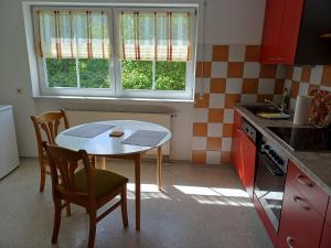 a kitchen with a table and two chairs and a table at FeWo Fink in Regen