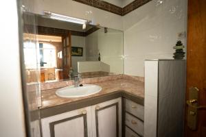 a bathroom with a sink and a mirror at Get Salty Guesthouse in Tamraght Ouzdar +90 photos