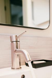 a bathroom sink with a faucet and a mirror at Pinedale Cozy Cabins in Pinedale +30 photos