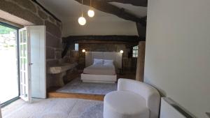 a bedroom with a bed and a chair at Caza de Cima de Villa in Penafiel +64 photos