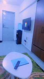 a room with a white table with a remote control on it at Urban Haven Homes in Kiambu