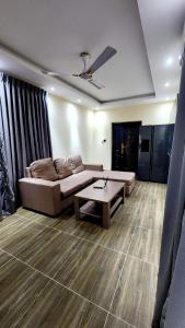 a living room with a couch and a coffee table at Executive Deluxe Studio Apt-Osu in Christiansborg