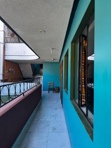 a corridor of a building with blue walls at Transilvania in Baños