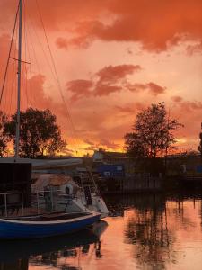a boat docked at a marina at sunset at La Mare Resort in Gothenburg +31 photos