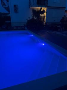 a swimming pool at night with blue lights at Slatine Residence apartament No2 in Slatine