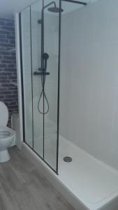 a bathroom with a glass shower with a toilet at Maison Conviviale amiens in Amiens