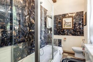 a bathroom with a tub shower and a toilet at Villa Mon Paradis in Lucca +71 photos