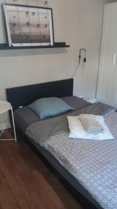 a bed with two pillows on it in a room at Maison Conviviale amiens in Amiens