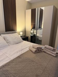 a bedroom with a large bed with towels on the floor at Slatine Residence apartament No2 in Slatine +20 photos