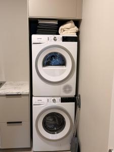 a washing machine and a washer in a kitchen at ScenicOceanview 4Free parking space 18 mins Downtown in Álftanes