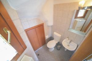 a small bathroom with a toilet and a sink at Sea View Maria in Fourka +18 photos