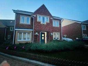 a brick house with purple flowers in front of it at The Trinity - Double Room Suite 1 with Study and En-suite in High Wycombe +13 photos