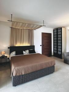 a bedroom with a large bed and a couch at Domo s'Altura in Porto Rotondo +27 photos