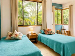 two beds in a room with a window at CasaBosque in Tarapoto +44 photos