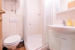 a bathroom with a toilet and a shower and a sink at Sea & Sky Retreat in Makarska +12 photos