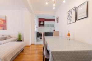 a living room with a table and a kitchen at Sea & Sky Retreat in Makarska