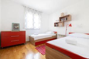 a bedroom with two beds and a window at Sea & Sky Retreat in Makarska
