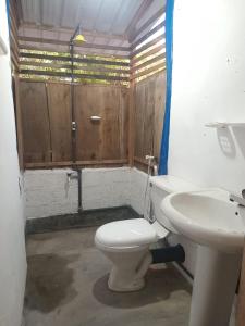 a bathroom with a toilet and a sink at Surfers Park Arugambay in Arugam Bay +48 photos