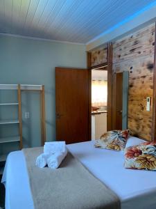 a bedroom with a bed with towels on it at Casa mussambé in Sao Jorge +43 photos