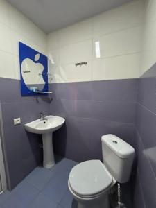a bathroom with a toilet and a sink at Bach-Ana in Ureki