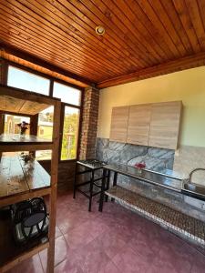a kitchen with a counter and a table in a room at Bach-Ana in Ureki +16 photos