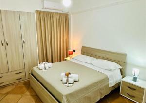 a bedroom with a large bed with two candles on it at View Ischia & Procida -Villa Lamberti Casa Panorama in Monte di Procida