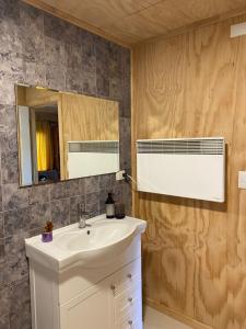 a bathroom with a sink and a mirror at Cabaña Payer in Villarrica +23 photos