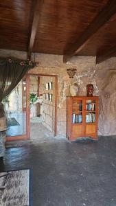 a room with a wooden cabinet in a stone building at Afrika Lodge in Kempton Park