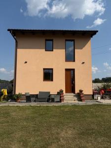a house with chairs in front of it at Countryside Apartments 252 in Poříčí nad Sázavou