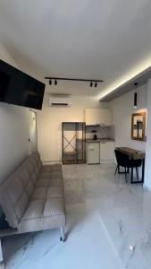a living room with a couch and a table at Studios Periklis in Limenas