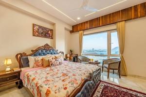 a bedroom with a bed and a large window at Mangal Residency in Bedla +80 photos