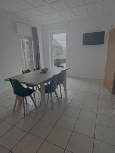 a table and chairs in a room with a large window at Apartment Wesel in Wesel