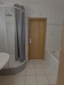 a bathroom with a tub and a toilet and a shower at Apartment Wesel in Wesel +4 photos