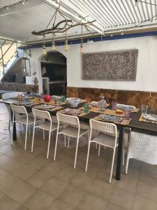 a dining room with a table and chairs and a fireplace at Eco- Refugio Centenario in Sagunto