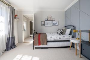 a white bedroom with a bed and a table at Hilltop in Woodbridge