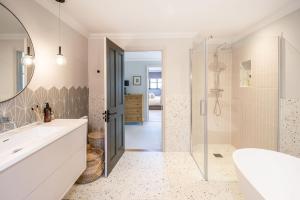 a bathroom with a sink and a shower and a mirror at Hilltop in Woodbridge +40 photos