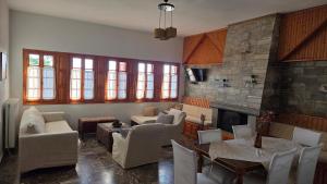 a living room with white chairs and a fireplace at Holiday Home Neochori Pelion in Neochori +35 photos