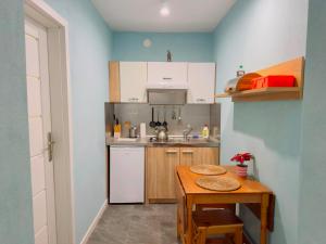 a small kitchen with a wooden table and a sink at Apartmány 149 u náměstí in Český Krumlov +19 photos