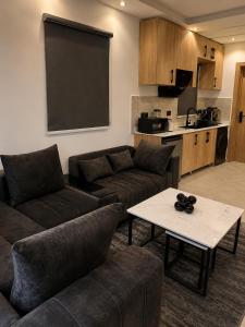 a living room with a couch and a table and a chalkboard at Ileero Homes The Beachfront in Lekki