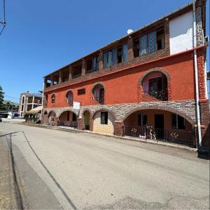 a red brick building on the side of a street at Bach-Ana in Ureki