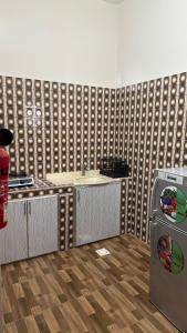a kitchen with a counter and a sink and a refrigerator at Reef Sinaw Apartments in Sinaw