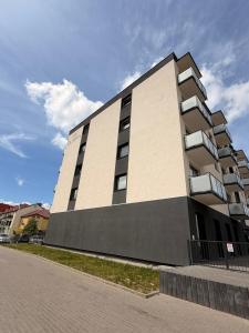 a large building with balconies on the side of it at Apartament 15 in Lębork