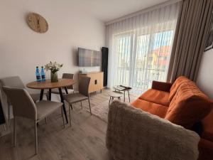 a living room with a couch and a table at Apartament 15 in Lębork