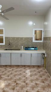 a kitchen with a counter and a sink in a room at Reef Sinaw Apartments in Sinaw +14 photos