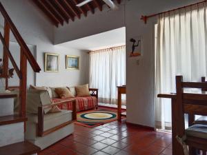 a living room with a couch and a table at Aguada Chica Bungalows in Villa Carlos Paz +29 photos